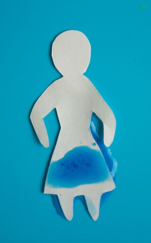 Urinary incontinence concept. Wet paper person. Blue background